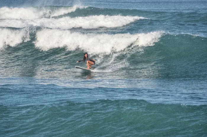 A surfer riding a green wave in Santa Teresa